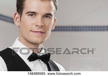Stock Photography - Portrait of a waiter smiling. Fotosearch