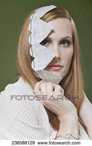 Portrait of a woman covering her face with a heart shaped paper chain View Large Photo Image Stock Photo - Portrait of a woman covering her face with a heart shaped paper chain. Fotosearch