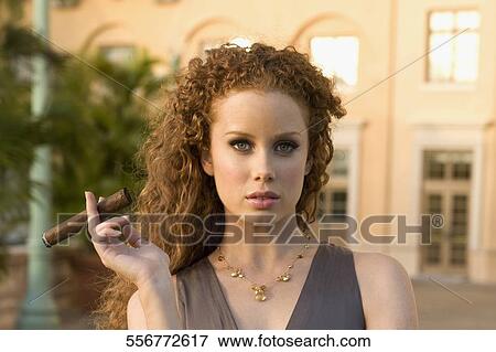 Portrait of a woman holding a cigar, Biltmore Hotel, Coral Gables, Florida, USA View Large Photo Image Stock Photo - Portrait of a woman holding a cigar, Biltmore Hotel, Coral Gables, Florida, USA. Fotosearch