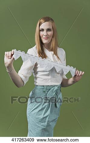 Portrait of a woman holding a heart shaped paper chain View Large Photo Image Stock Photo - Portrait of a woman holding a heart shaped paper chain. Fotosearch