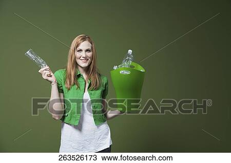 Portrait of a woman holding a recycling bin View Large Photo Image Stock Image - Portrait of a woman holding a recycling bin. Fotosearch