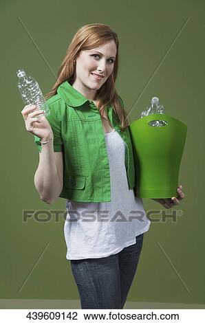 Portrait of a woman holding a recycling bin View Large Photo Image Stock Image - Portrait of a woman holding a recycling bin. Fotosearch