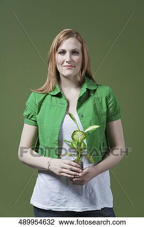 Portrait of a woman holding a seedling View Large Photo Image Stock Image - Portrait of a woman holding a seedling. Fotosearch