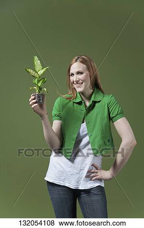 Portrait of a woman holding a seedling View Large Photo Image Stock Photo - Portrait of a woman holding a seedling. Fotosearch