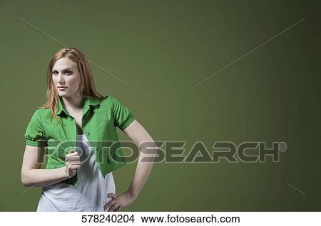 Picture - Portrait of a woman holding her shirt. Fotosearch