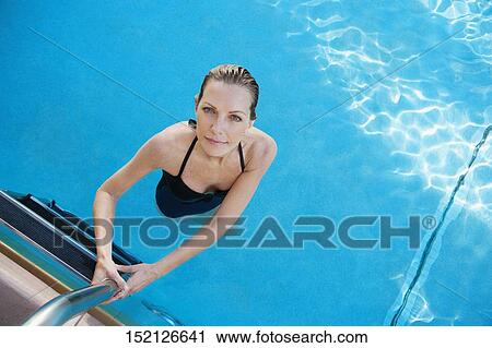 Stock Image - Portrait of a woman in a swimming pool, Biltmore Hotel, Coral Gables, Florida, USA. Fotosearch