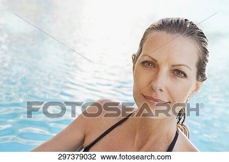 Stock Image - Portrait of a woman in a swimming pool, Biltmore Hotel, Coral Gables, Florida, USA. Fotosearch