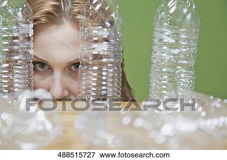 Portrait of a woman looking through bottles View Large Photo Image Stock Photo - Portrait of a woman looking through bottles. Fotosearch