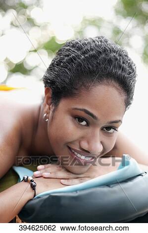 Portrait of a woman lying on a massage table View Large Photo Image Stock Image - Portrait of a woman lying on a massage table. Fotosearch