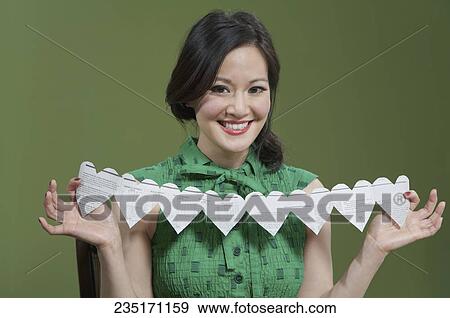 Portrait of a woman showing a paper chain View Large Photo Image Stock Photo - Portrait of a woman showing a paper chain. Fotosearch