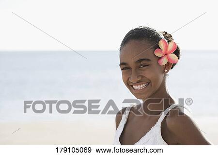 Stock Photo - Portrait of a woman smiling on the beach. Fotosearch