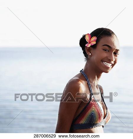 Stock Photo - Portrait of a woman smiling on the beach. Fotosearch