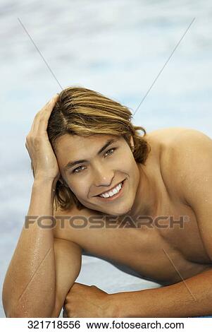 Portrait of a young man smiling View Large Photo Image Stock Photograph - Portrait of a young man smiling. Fotosearch