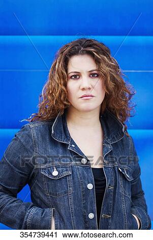 Portrait of a young woman looking serious View Large Photo Image Stock Image - Portrait of a young woman looking serious. Fotosearch