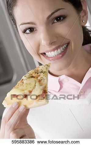 Portrait of female chef holding a pizza slice View Large Photo Image Stock Photograph - Portrait of female chef holding a pizza slice. Fotosearch