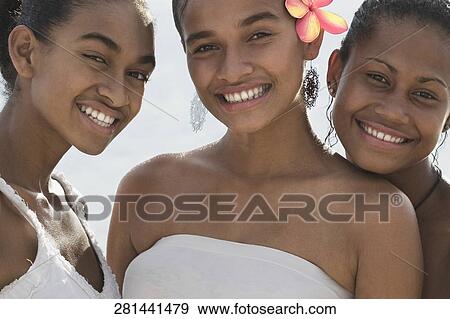 Portrait of three female friends smiling on the beach View Large Photo Image Stock Photo - Portrait of three female friends smiling on the beach. Fotosearch