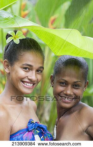 Portrait of two female friends enjoying rain and smiling View Large Photo Image Picture - Portrait of two female friends enjoying rain and smiling. Fotosearch