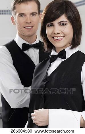 Portrait of two waiters in a restaurant View Large Photo Image Stock Image - Portrait of two waiters in a restaurant. Fotosearch