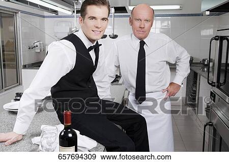 Portrait of two waiters smiling View Large Photo Image Stock Photo - Portrait of two waiters smiling. Fotosearch