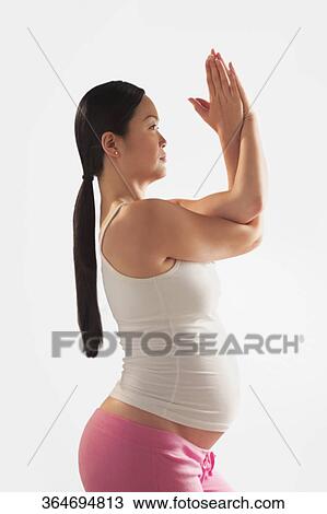 Pregnant woman practicing yoga View Large Photo Image Stock Image - Pregnant woman practicing yoga. Fotosearch