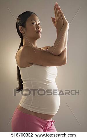 Pregnant woman practicing yoga View Large Photo Image Stock Image - Pregnant woman practicing yoga. Fotosearch