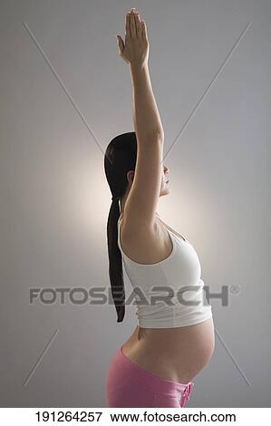 Stock Photo - Pregnant woman practicing yoga. Fotosearch