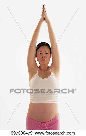 Stock Photo - Pregnant woman practicing yoga. Fotosearch