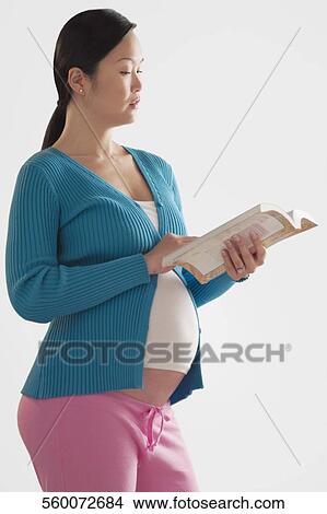 Pregnant woman reading a book View Large Photo Image Picture - Pregnant woman reading a book. Fotosearch