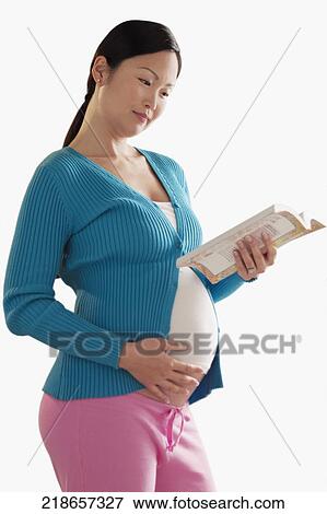 Pregnant woman reading a book View Large Photo Image Stock Photo - Pregnant woman reading a book. Fotosearch