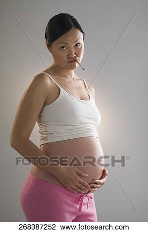 Pregnant woman smoking a cigarette View Large Photo Image Stock Image - Pregnant woman smoking a cigarette. Fotosearch