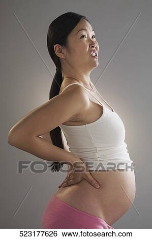 Pregnant woman suffering from backache View Large Photo Image Stock Photograph - Pregnant woman suffering from backache. Fotosearch