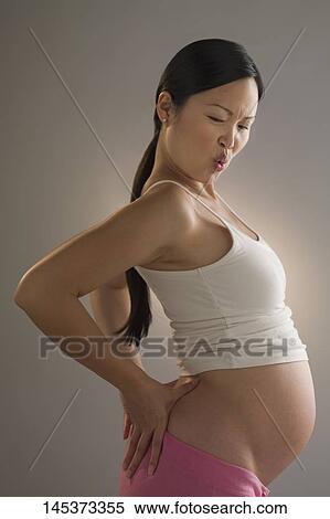 Pregnant woman suffering from backache View Large Photo Image Stock Photography - Pregnant woman suffering from backache. Fotosearch