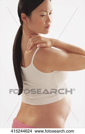 Pregnant woman suffering from neckache View Large Photo Image Picture - Pregnant woman suffering from neckache. Fotosearch
