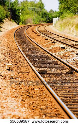 Stock Photo - Railroad track passing through a landscape. Fotosearch
