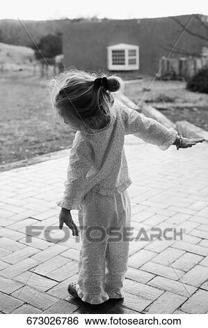 Rear view of a baby girl with her arms outstretched, Santa Fe, New Mexico, USA View Large Photo Image Stock Photograph - Rear view of a baby girl with her arms outstretched, Santa Fe, New Mexico, USA. Fotosearch