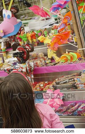 Rear view of a girl at a market stall View Large Photo Image Stock Image - Rear view of a girl at a market stall. Fotosearch
