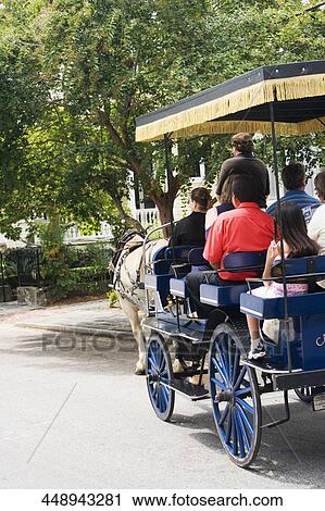 Rear view of a group of people traveling in a horse cart View Large Photo Image Stock Image - Rear view of a group of people traveling in a horse cart. Fotosearch