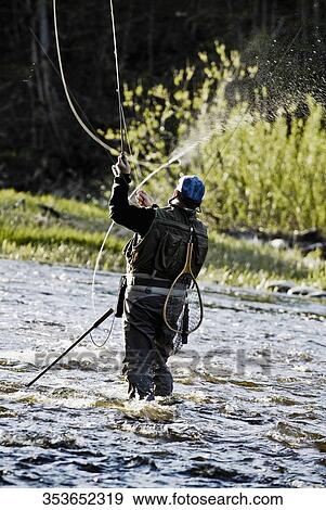 Rear view of a man fishing View Large Photo Image Stock Photo - Rear view of a man fishing. Fotosearch