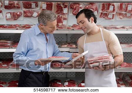 Sales clerk assisting a customer choosing meat in a supermarket View Large Photo Image Stock Photo - Sales clerk assisting a customer choosing meat in a supermarket. Fotosearch
