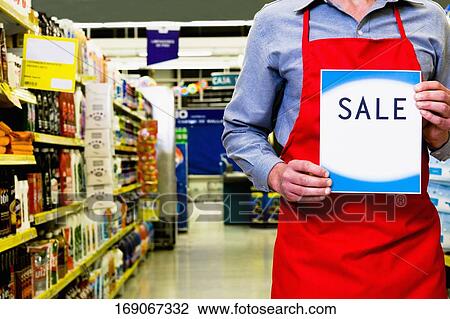 Sales clerk holding a sale signboard View Large Photo Image Stock Image - Sales clerk holding a sale signboard. Fotosearch