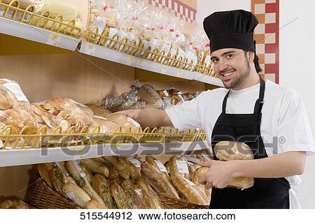 Sales clerk holding breads in a supermarket View Large Photo Image Stock Image - Sales clerk holding breads in a supermarket. Fotosearch