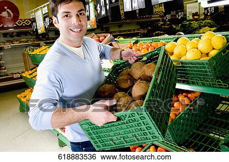 Sales clerk in a supermarket View Large Photo Image Stock Photograph - Sales clerk in a supermarket. Fotosearch