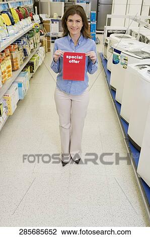 Sales clerk showing Special Offer sign in a supermarket View Large Photo Image Stock Image - Sales clerk showing Special Offer sign in a supermarket. Fotosearch