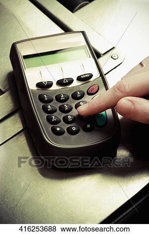 Sales clerk using a credit card reader at counter View Large Photo Image Stock Photo - Sales clerk using a credit card reader at counter. Fotosearch