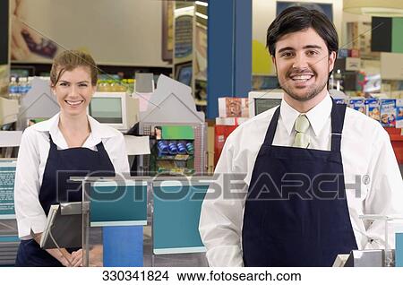 Sales clerks smiling in a supermarket View Large Photo Image Picture - Sales clerks smiling in a supermarket . Fotosearch