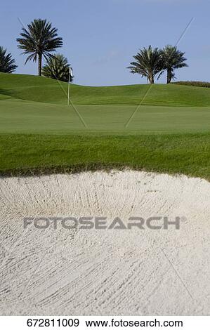 Sand trap in a golf course View Large Photo Image Stock Photo - Sand trap in a golf course. Fotosearch
