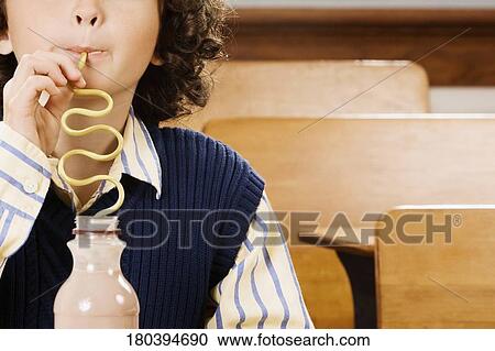 Schoolboy drinking chocolate milkshake in a classroom View Large Photo Image Stock Image - Schoolboy drinking chocolate milkshake in a classroom. Fotosearch