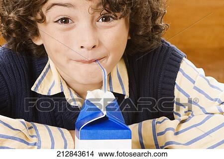 Schoolboy drinking juice in a classroom View Large Photo Image Picture - Schoolboy drinking juice in a classroom. Fotosearch