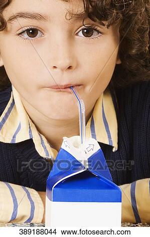 Schoolboy drinking juice in a classroom View Large Photo Image Picture - Schoolboy drinking juice in a classroom. Fotosearch