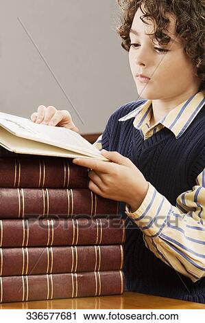Stock Image - Schoolboy studying in a classroom. Fotosearch